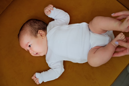 newborn baby lies on the dewan. newborn baby shows different emotions
