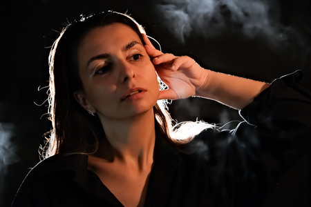 silhouette of a girl in the dark. smoke. steam. girl in a dark room.の写真素材