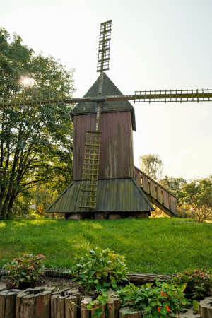 Old wooden windmill in the park on a sunny summer day.の写真素材