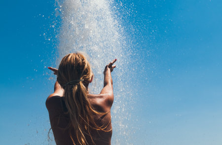 Girl against the blue sky and splashesの写真素材