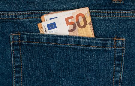Fifty euro banknotes in blue jeans pocketの写真素材