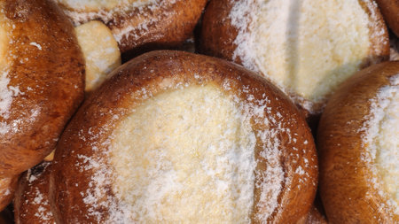 Pile of freshly baked buns with cottage cheese and powdered sugarの写真素材