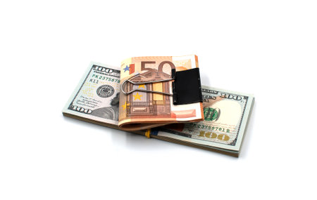 Banknotes of one hundred dollars and fifty euros on a white background.の写真素材
