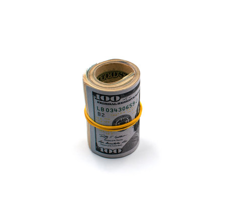 A roll of American hundred dollar bills tied with an elastic band isolated on a white background.
