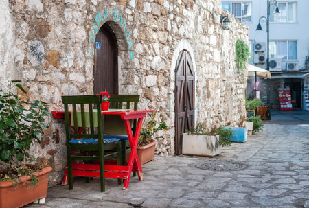 Charming street cafe with stone wall and colorful furniture in Marmaris old townの写真素材