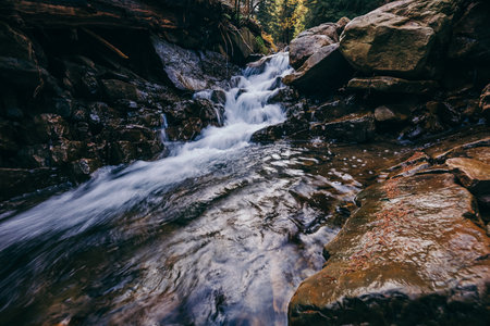 A large waterfall over a rocky cliffの写真素材