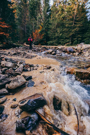A waterfall in a forest a mountainの写真素材