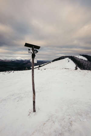 A snow covered field in snow a mountain