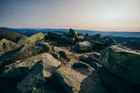 A rocky island in the middle of a body of waterの写真素材