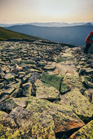 A man standing on a rocky hillの写真素材