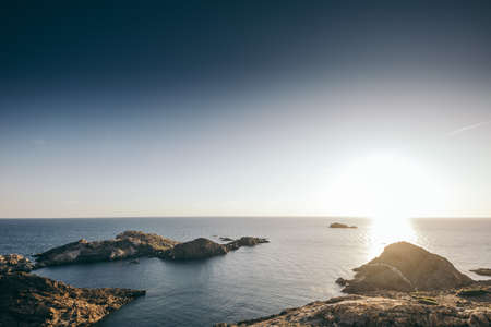 A close up of a rock next to a body of waterの写真素材