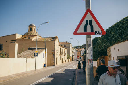 A person holding a stop sign on the side of the streetの写真素材