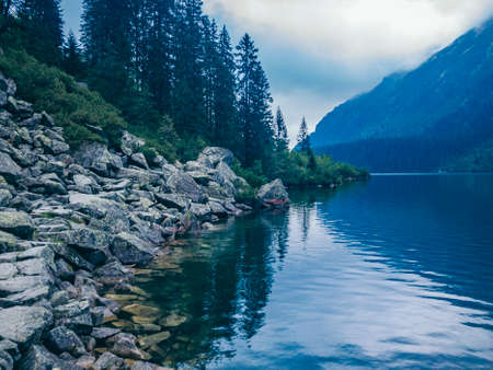 A lake with a mountain in the backgroundの写真素材