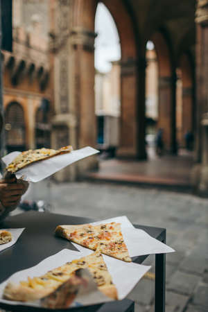 A slice of pizza sitting on top of a tableの写真素材