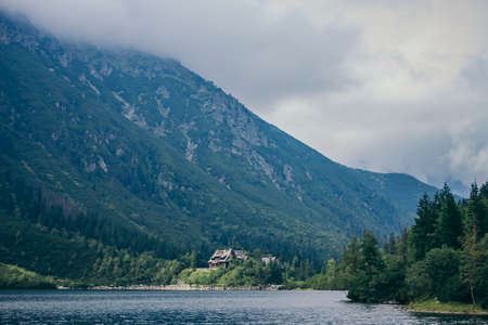 A body of water with a mountain in the backgroundの写真素材