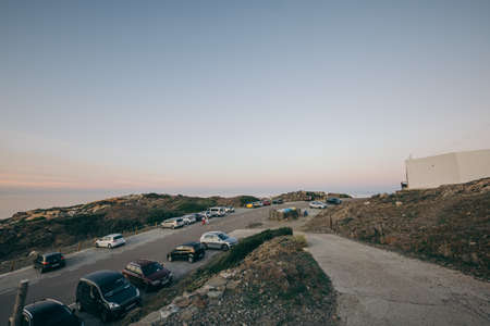 A row of cars parked on the side of a roadの写真素材