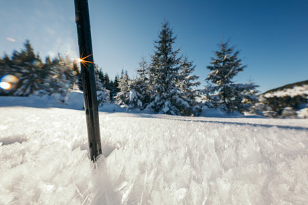 A man riding skis down a snow covered slopeの写真素材