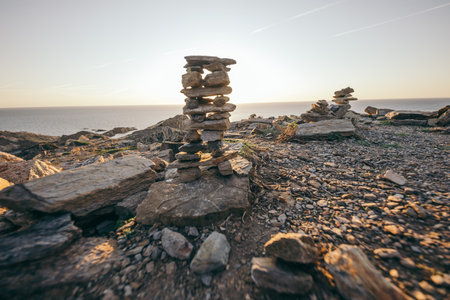 A rocky island in the middle of a body of waterの写真素材