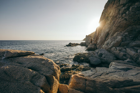 A close up of a rock next to a body of waterの写真素材