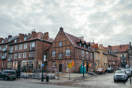 A street with cars parked on the side of a buildingの写真素材
