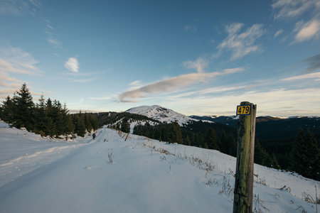 A sign on the side of a snow covered slopeの写真素材