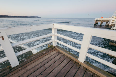 A wooden bench overlooking a body of water