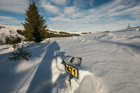 A man riding a snowboard down a snow covered slopeの写真素材