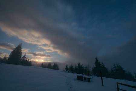 A sign above a snow covered slopeの写真素材