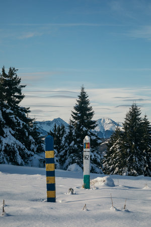 A sign on the side of a snow covered slopeの写真素材