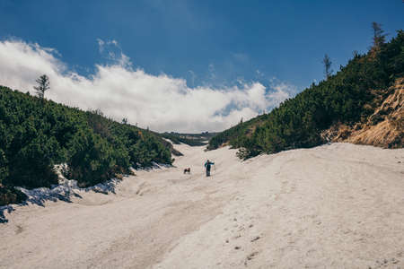 A group of people walking down a dirt roadの写真素材