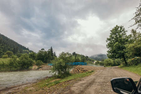 A train is parked on the side of a dirt roadの写真素材