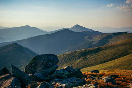 A rocky mountain with trees in the backgroundの写真素材