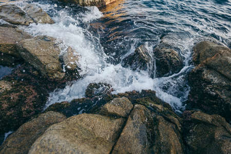 A large waterfall over a rocky cliffの写真素材
