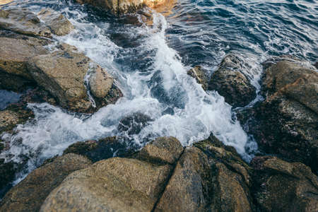 A large waterfall over a rocky cliffの写真素材