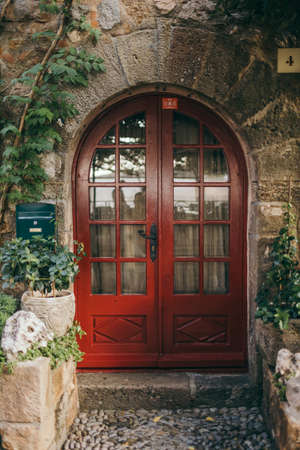 A stone building that has a bench in front of a doorの写真素材