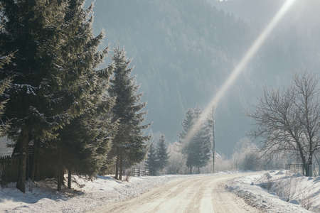 A rainbow over a snow covered slopeの写真素材