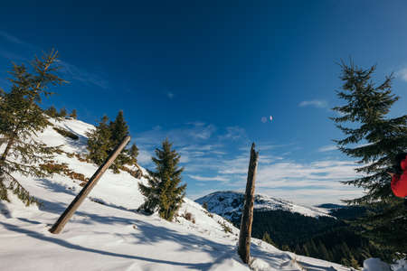 A man riding skis down a snow covered slopeの写真素材