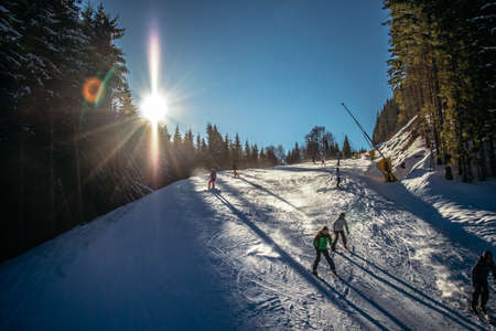 A person riding skis down a snow covered slopeの写真素材