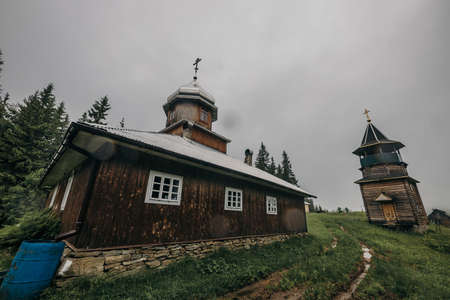 A small clock tower in front of a houseの写真素材
