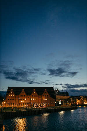 A sign lit up at nightの写真素材