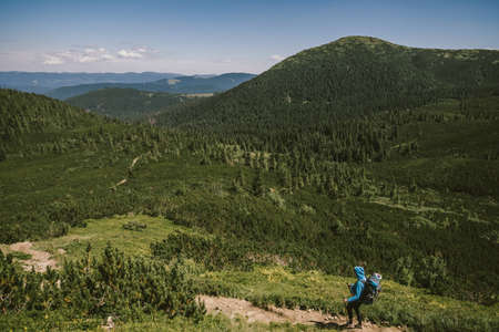 A person standing in front of a mountainの写真素材