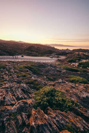 A rocky mountain with trees in the backgroundの写真素材