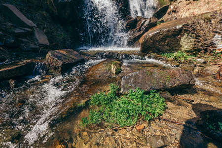 A large waterfall over a rocky cliffの写真素材