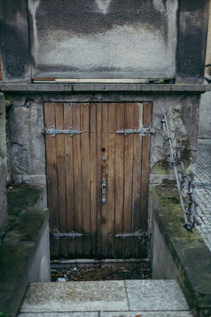 A wooden bench on the side of a buildingの写真素材