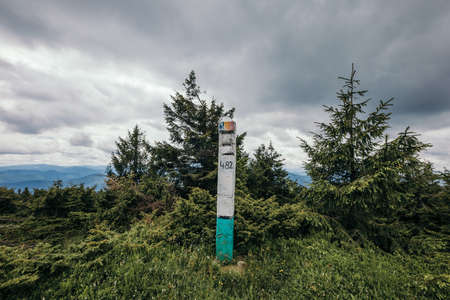 A sign on a grassy hillの写真素材