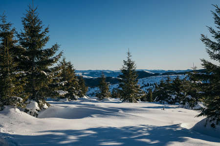 A man riding on top of a snow covered slopeの写真素材