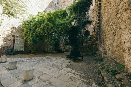 A stone building that has a sign on a rockの写真素材