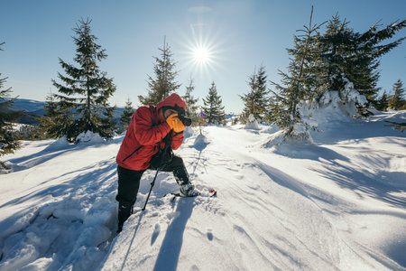 A person riding skis down a snow covered slopeの写真素材