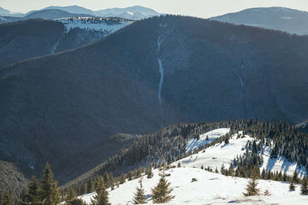 A man riding a snowboard down a snow covered mountainの写真素材