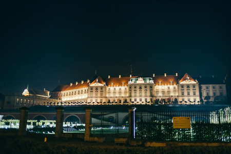 A clock tower lit up at nightの写真素材
